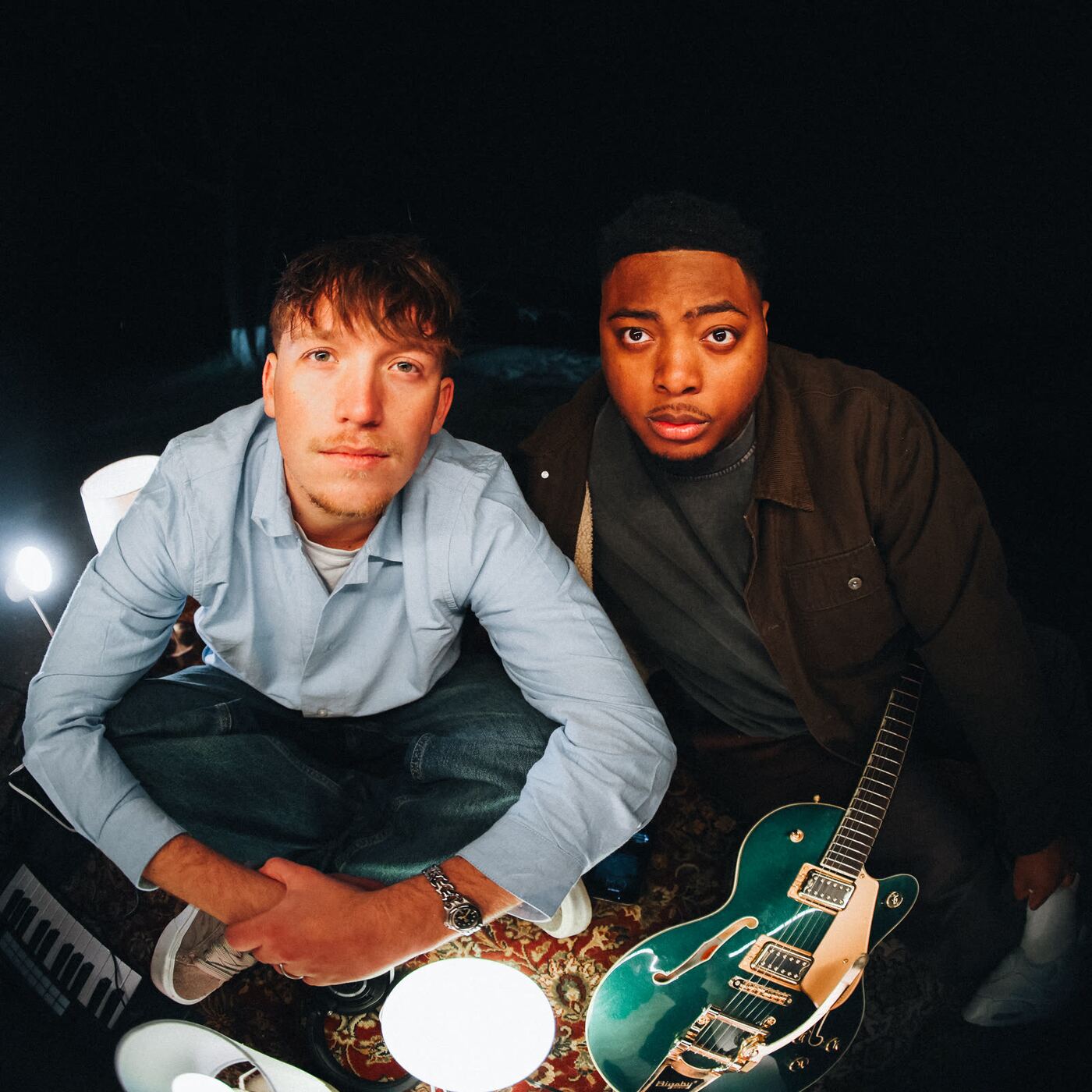 Jude and Sincer with a guitar by the lake