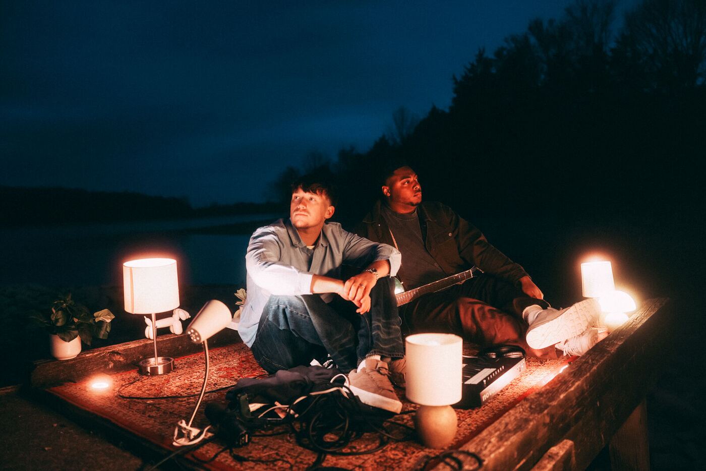 Jude Barclay and Sincer playing music by a lake at night