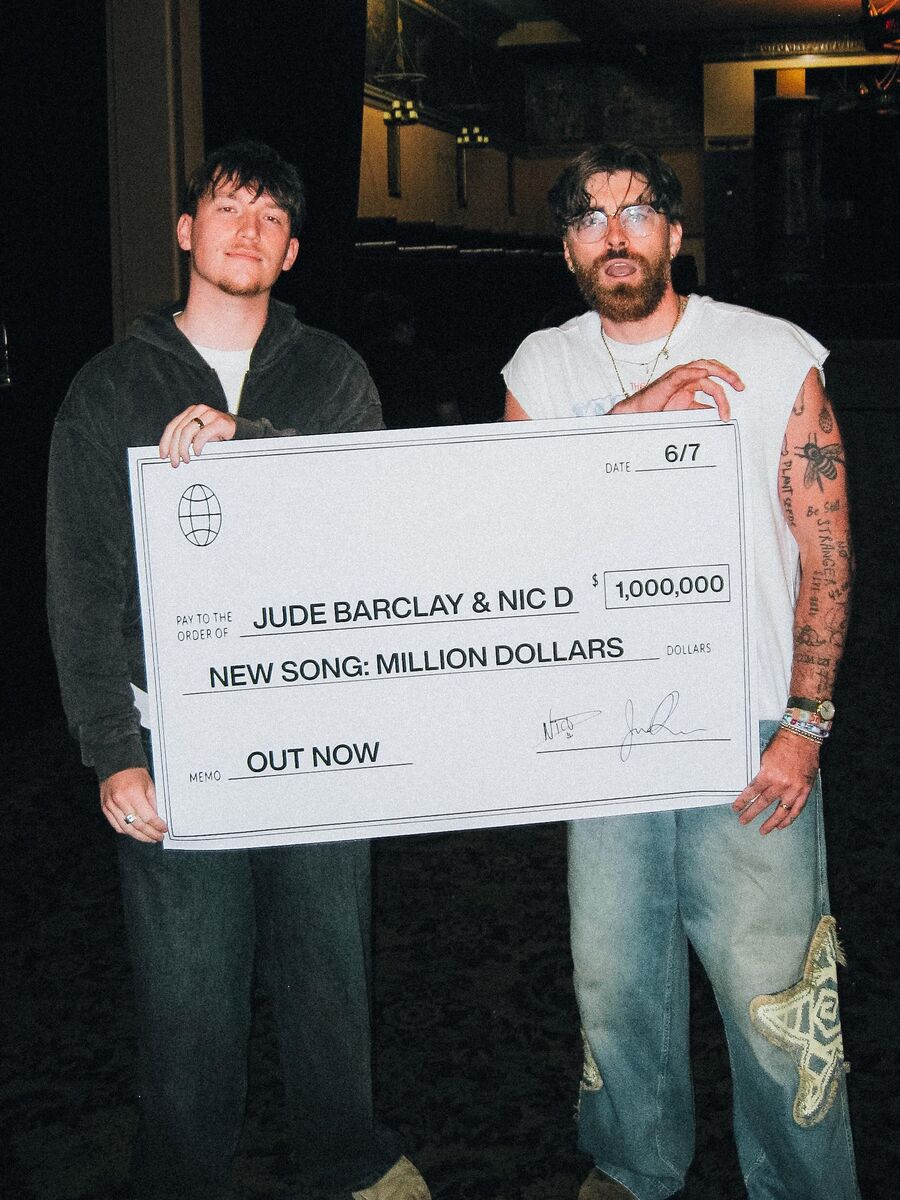 Jude and Nic D holding the million dollars check
