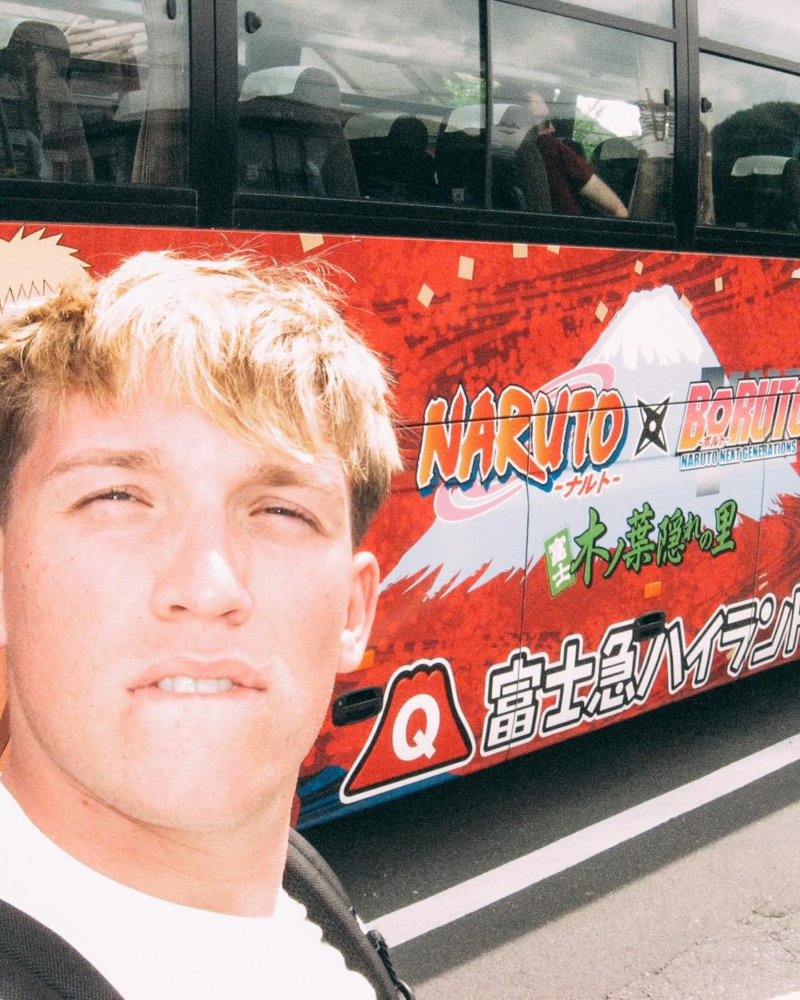 Jude in front of a Naruto bus
