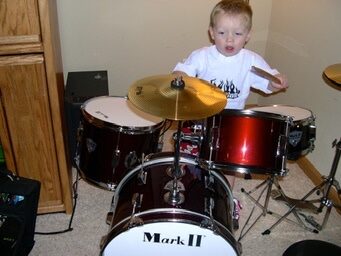 Jude as a little kid on a drum kit