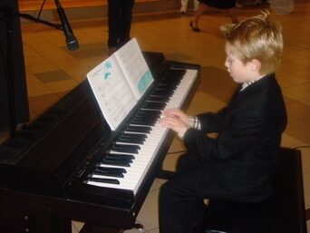 Jude as a kid at the piano