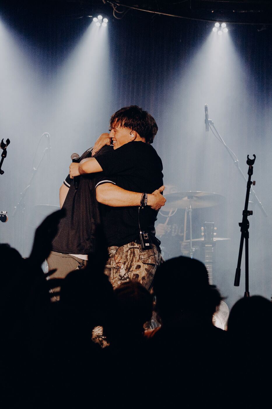 Jude and John Michael Howell hugging on stage