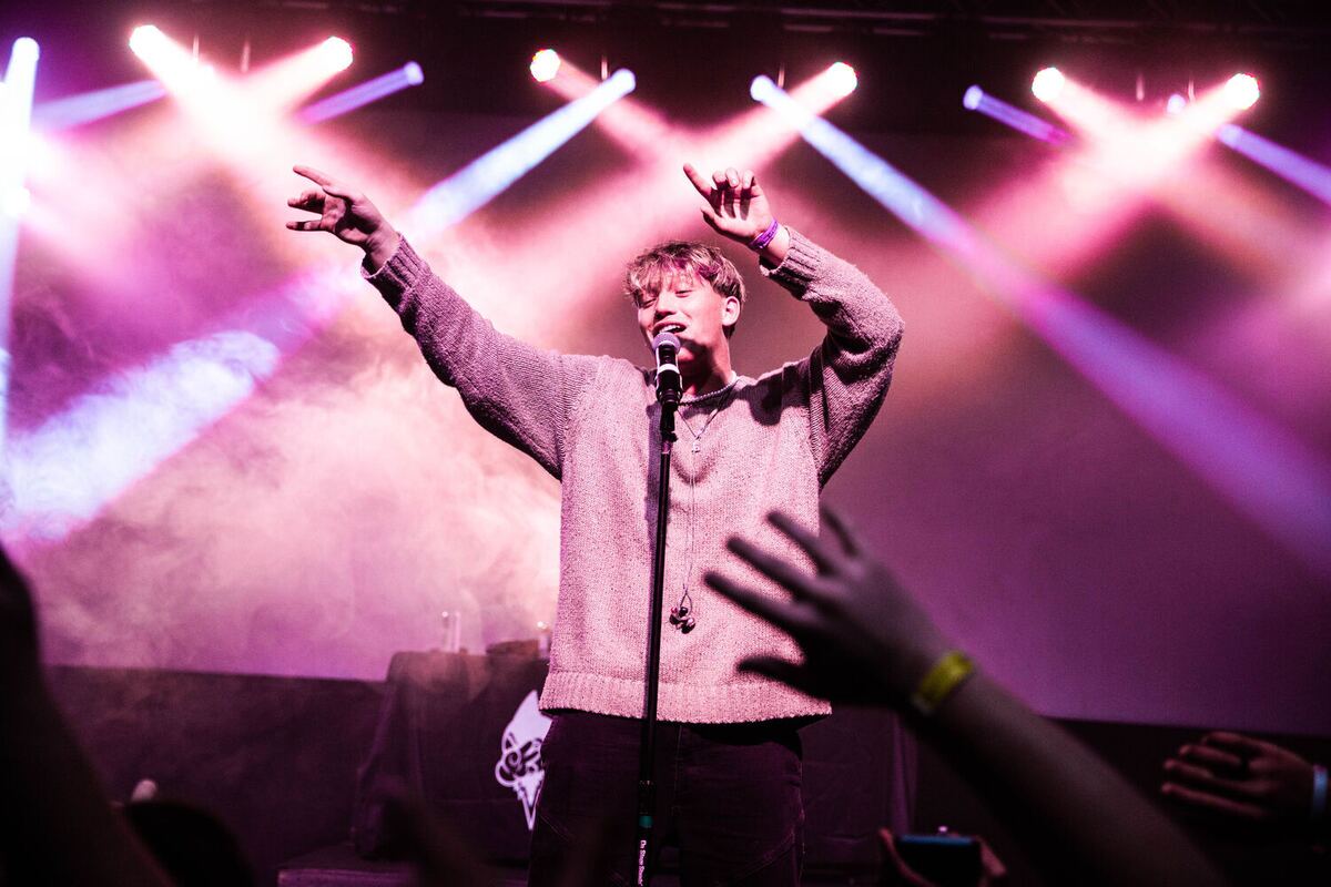 Jude on a pink-lit stage