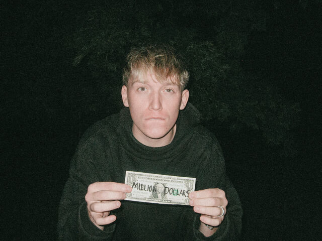 Jude Barclay holding a million dollars bill