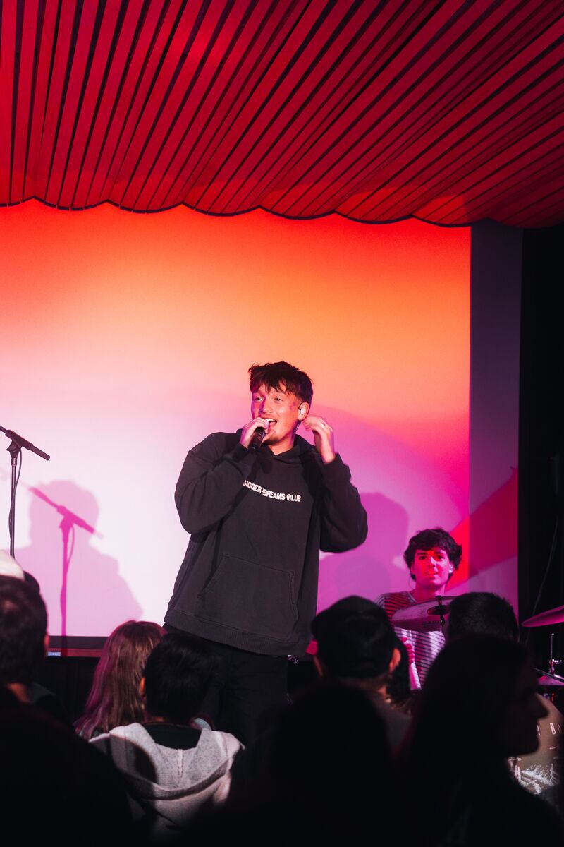 Jude on a red-lit stage in Portland